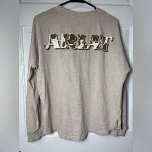 Small ARIAT" graphic on the back cowhide-patterned fill and a drop-shadow effect